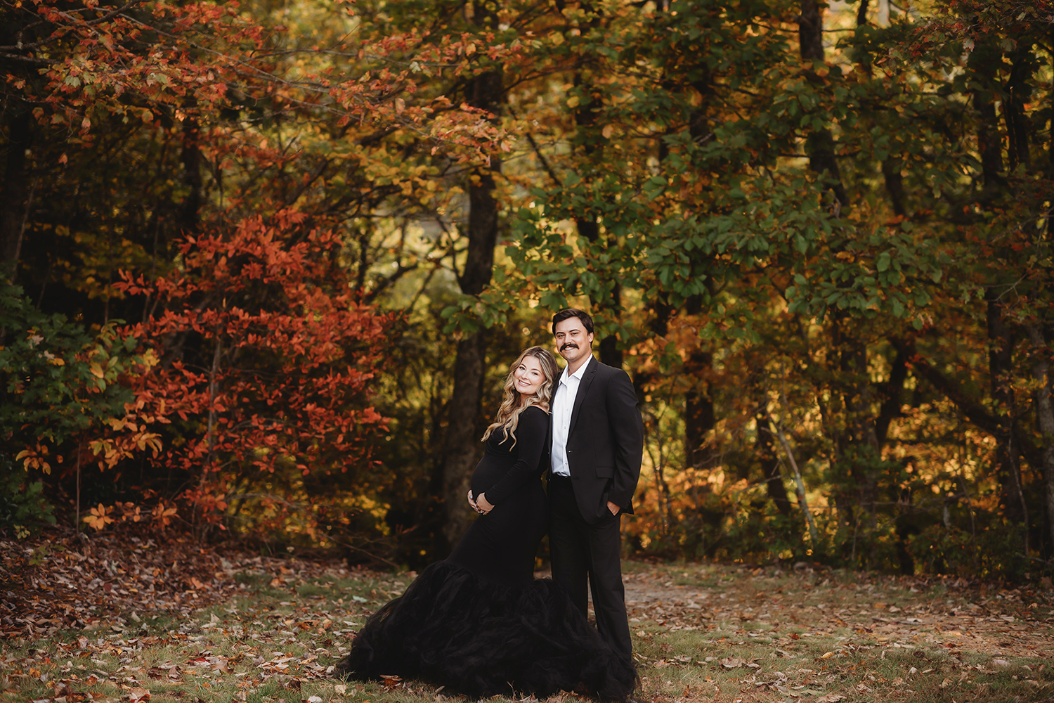 Expectant parents pose for Maternity Portraits in the Fall on the Blue Ride Parkway in Asheville, NC.