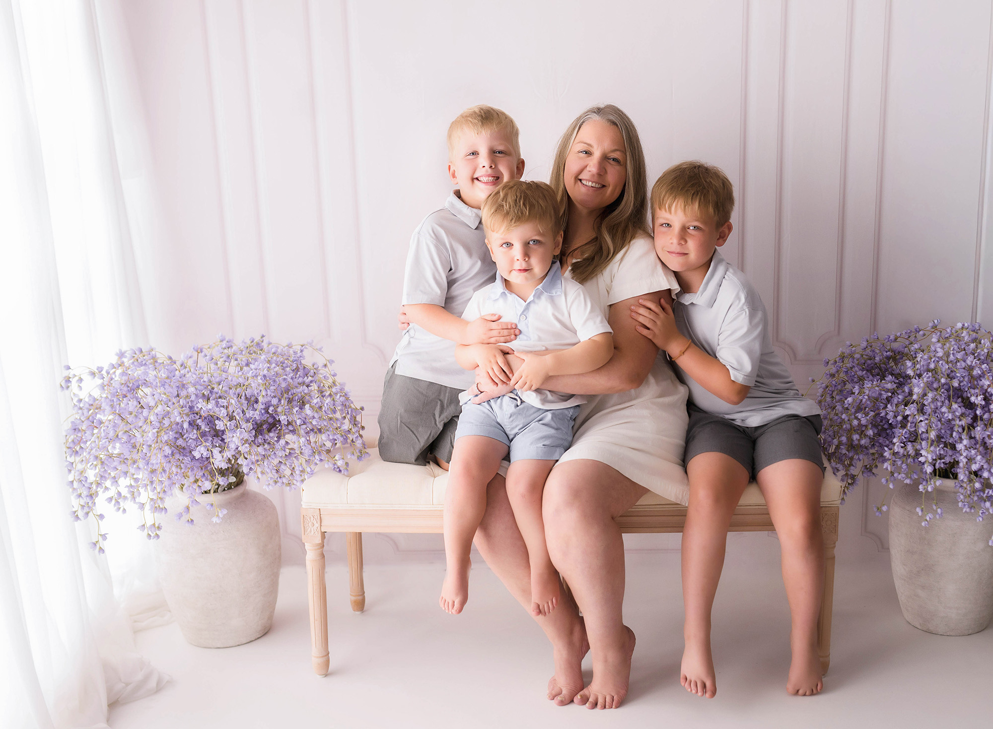 Mother Embraces her children during Mother's Day Mini Sessions in Asheville.