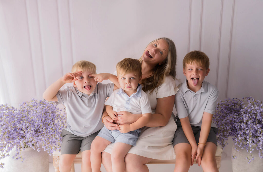 Mother embraces her children during Mother's Day Mini Session in Asheville, NC. 