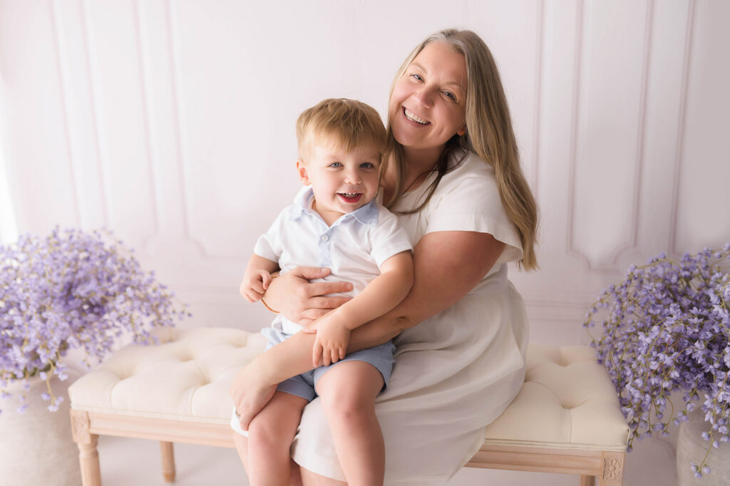 Mother embraces her baby during Mother's Day Mini Session in Asheville, NC. 