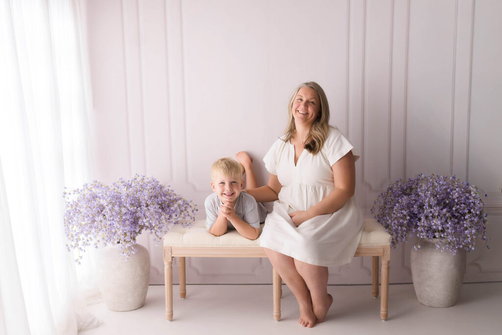 Mother sits with her middle child during Mother's Day Mini Session in Asheville, NC. 