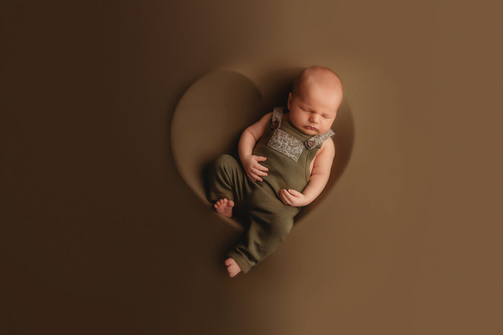 Infant posed for Newborn Photos in Asheville, NC while his mother worked with Lactation Consultants in Asheville. 