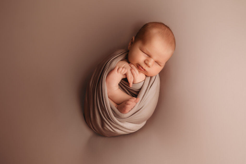 Infant posed for Newborn Photoshoot in Asheville, NC. 