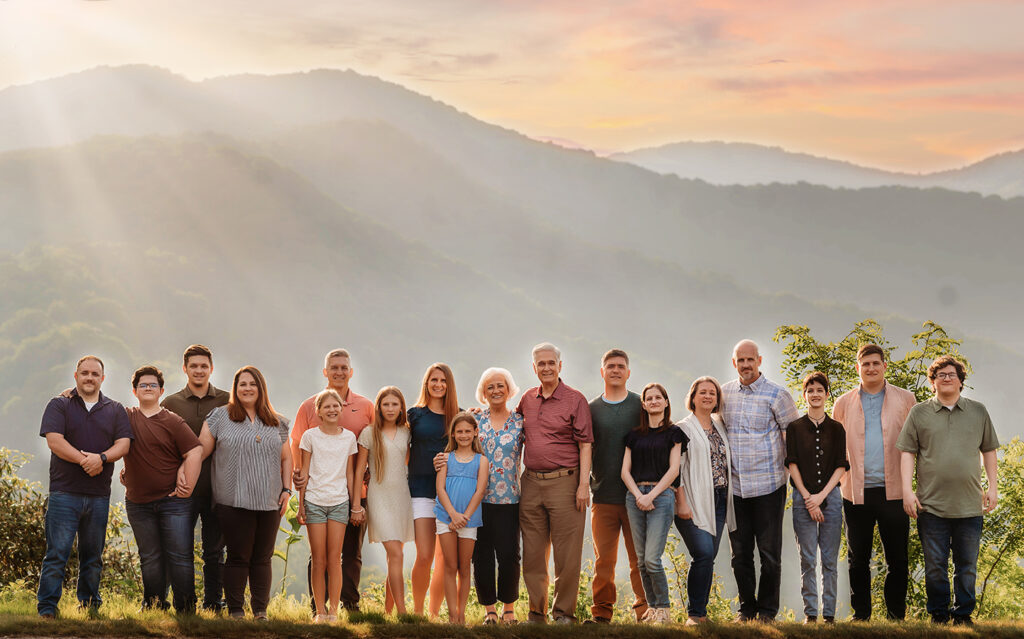 Large, extended family poses for portraits during their Family Reunion Photoshoot in Asheville, NC. 