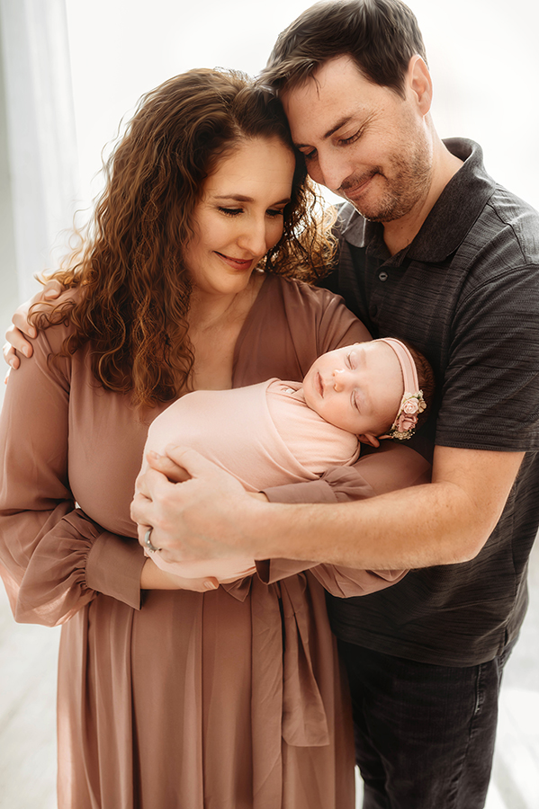 New Parents cradle their Newborn Baby during Newborn Portrait Session in Asheville, NC.