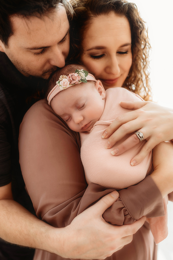 New Parents cradle their Newborn Baby during Newborn Portrait Session in Asheville, NC.