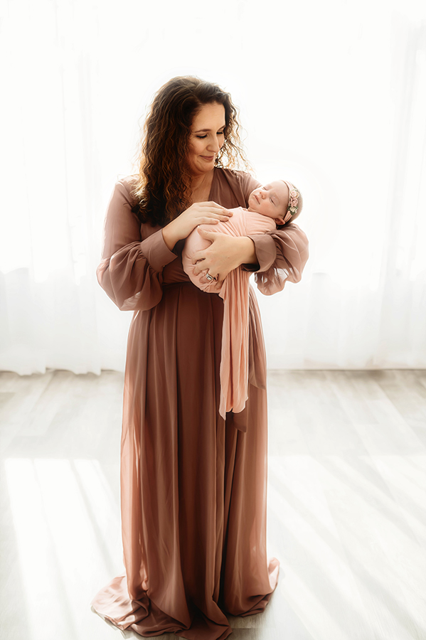 Mother cradles Newborn Baby during Newborn Portrait Session in Asheville, NC.