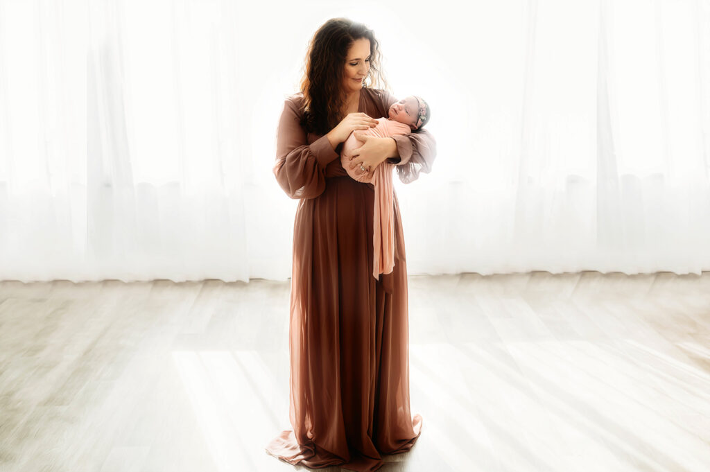 Mother cradles Newborn Baby during Newborn Portrait Session in Asheville, NC.
