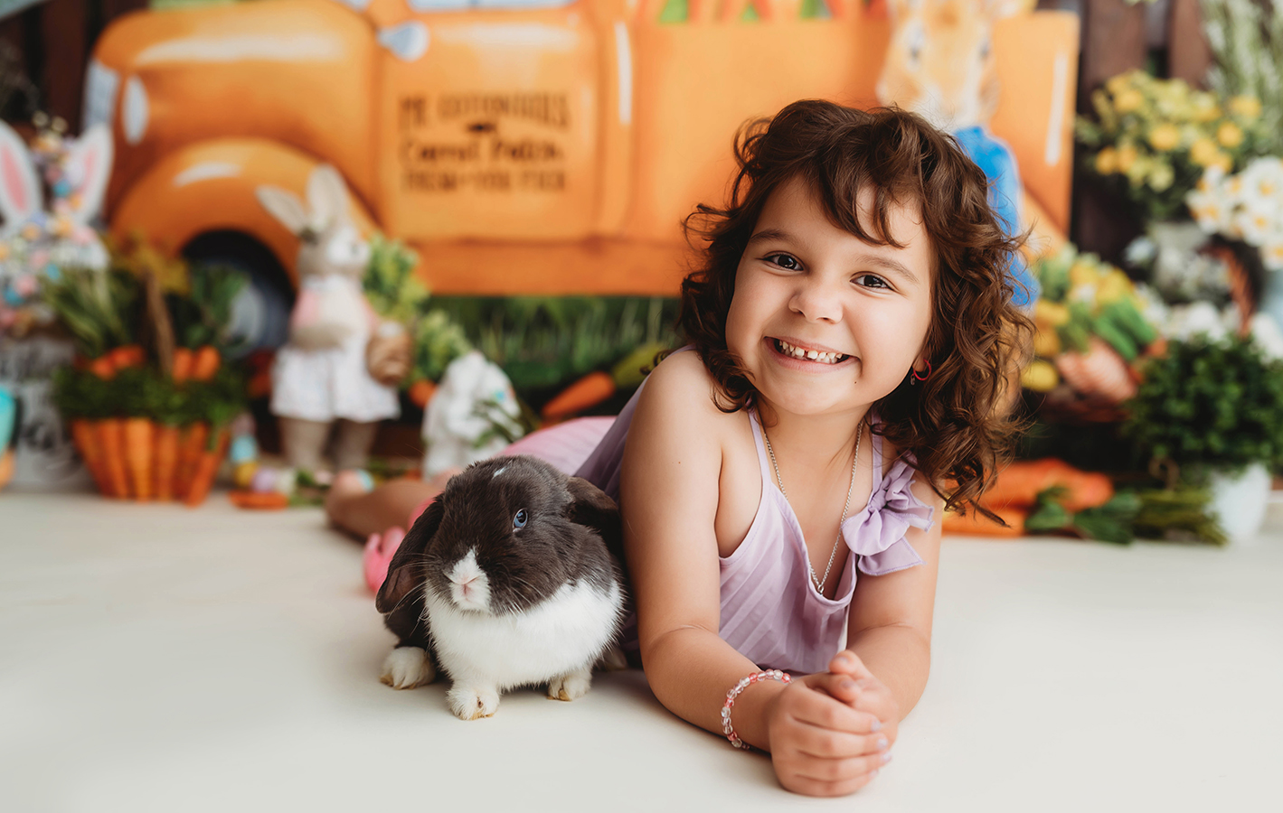 Little girl poses with bunny rabbit for Easter Mini Session at Asheville, NC Portrait Photography Studio.