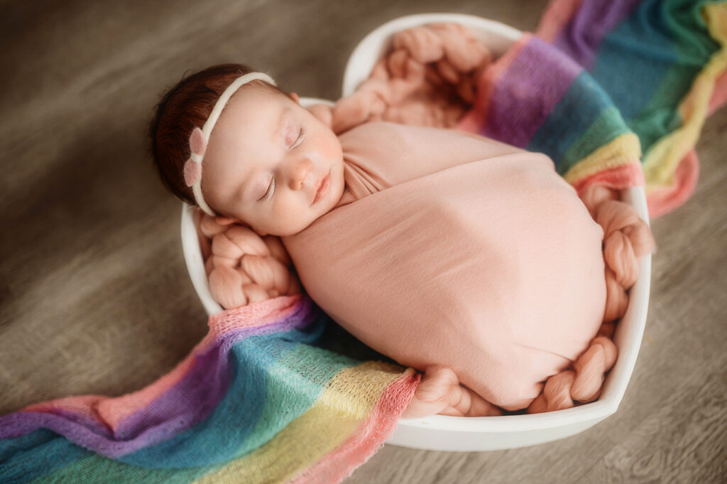 Newborn Baby posed in a rainbow baby set during Newborn Portrait Session in Asheville, NC.