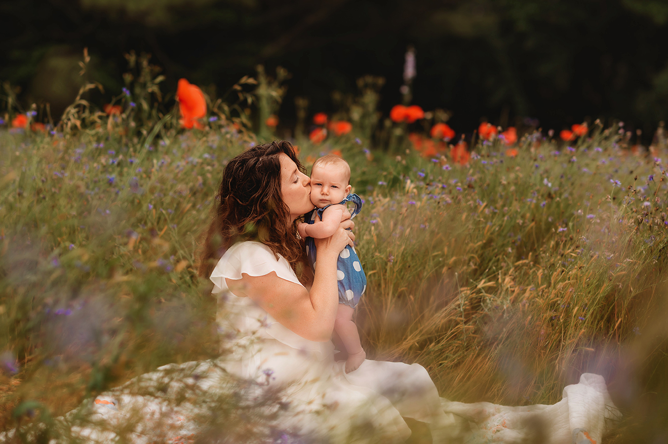 Mother embraces her infant during a Mother's Day Mini Session in Asheville, NC