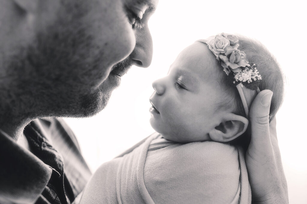 Father cradles his Newborn Baby during Newborn Portrait Session in Asheville, NC.