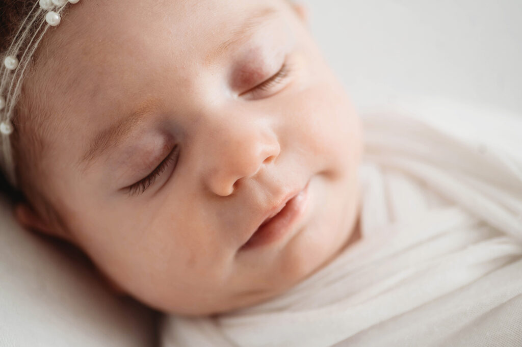 Newborn Baby posed in an all white set during a Newborn Portrait Session in Asheville, NC.