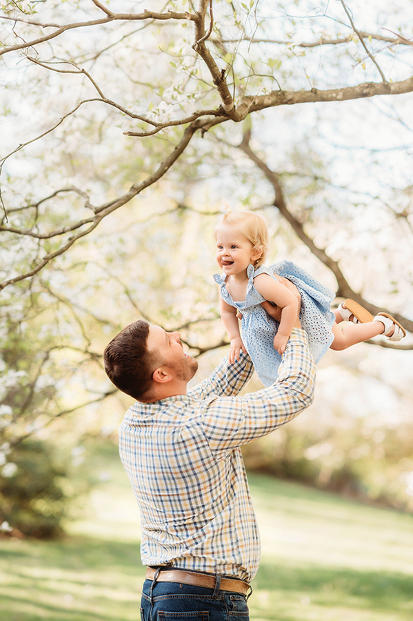 Dad embraces his baby during a Spring Photoshoot in Ashville, NC.