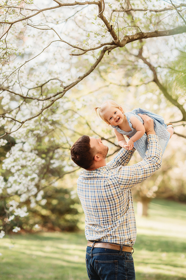Dad embraces his baby during a Spring Photoshoot in Ashville, NC.