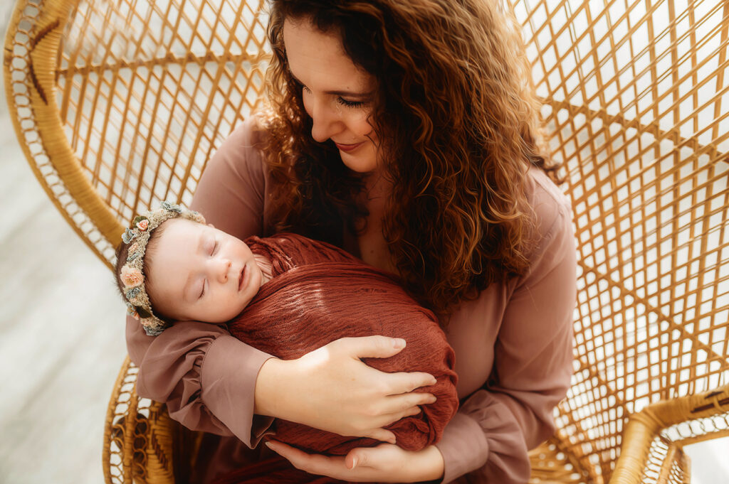 Mother cradles Newborn Baby during Newborn Portrait Session in Asheville, NC.