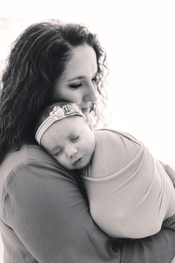 Mother cradles Newborn Baby during Newborn Portrait Session in Asheville, NC.