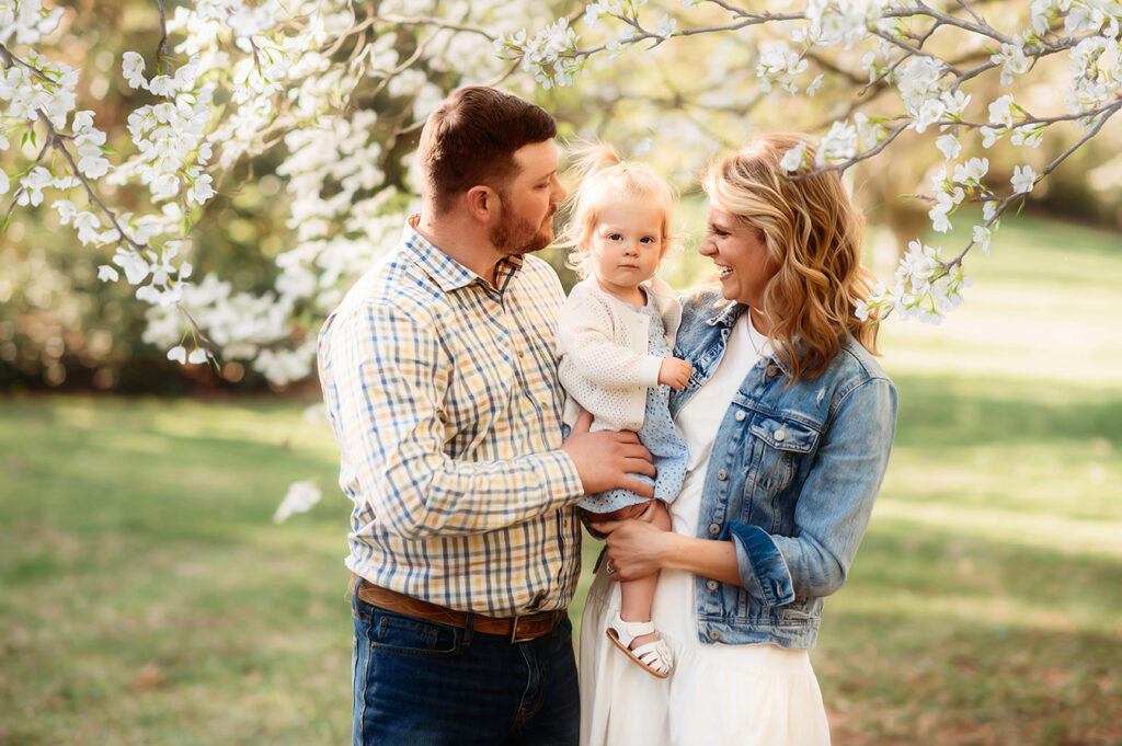 Parents embrace their baby during a Spring Photoshoot in Ashville, NC.