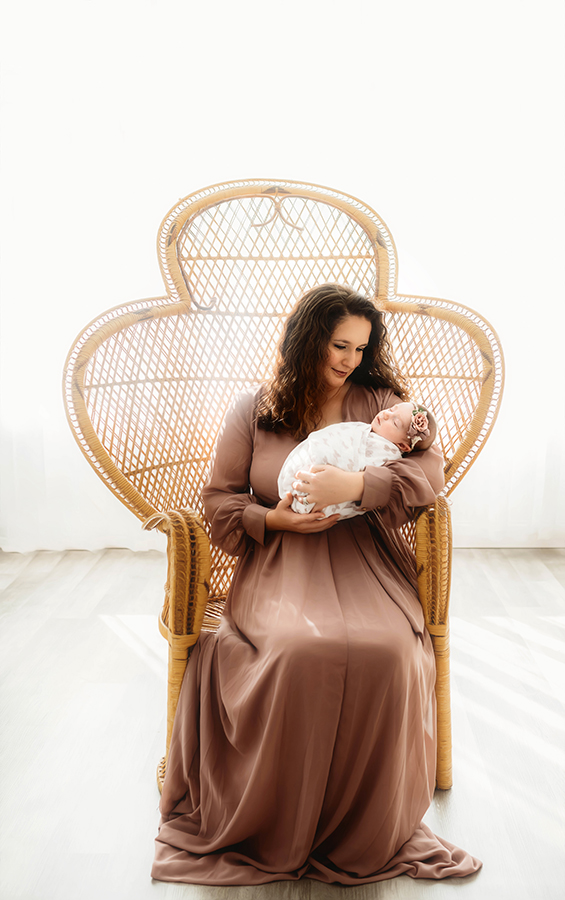 Mother cradles Newborn Baby during Newborn Portrait Session in Asheville, NC.