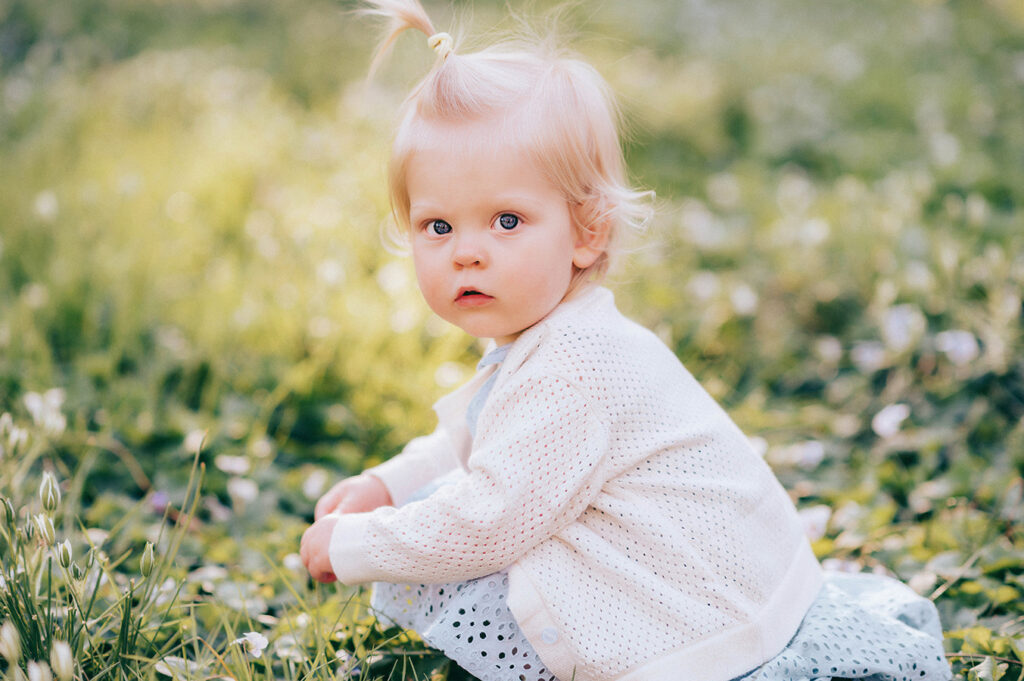 Baby plays in a field of flowers during a Spring Photoshoot in Asheville, NC.