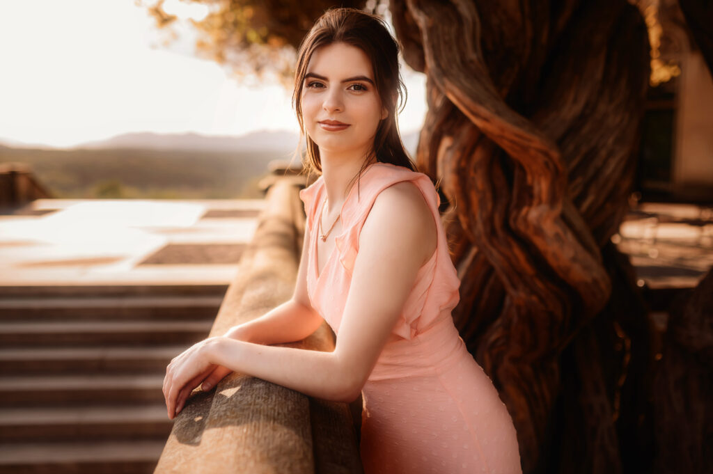 Young woman poses for Senior Photos at Biltmore Estate in Asheville, NC.