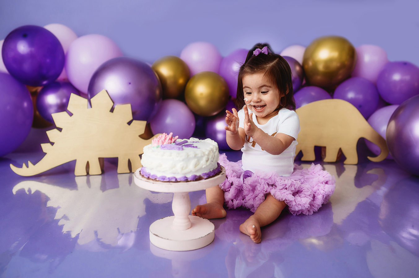 One year old baby girl celebrates her first birthday with a cake smash portrait session at an Asheville, NC Portrait Studio.