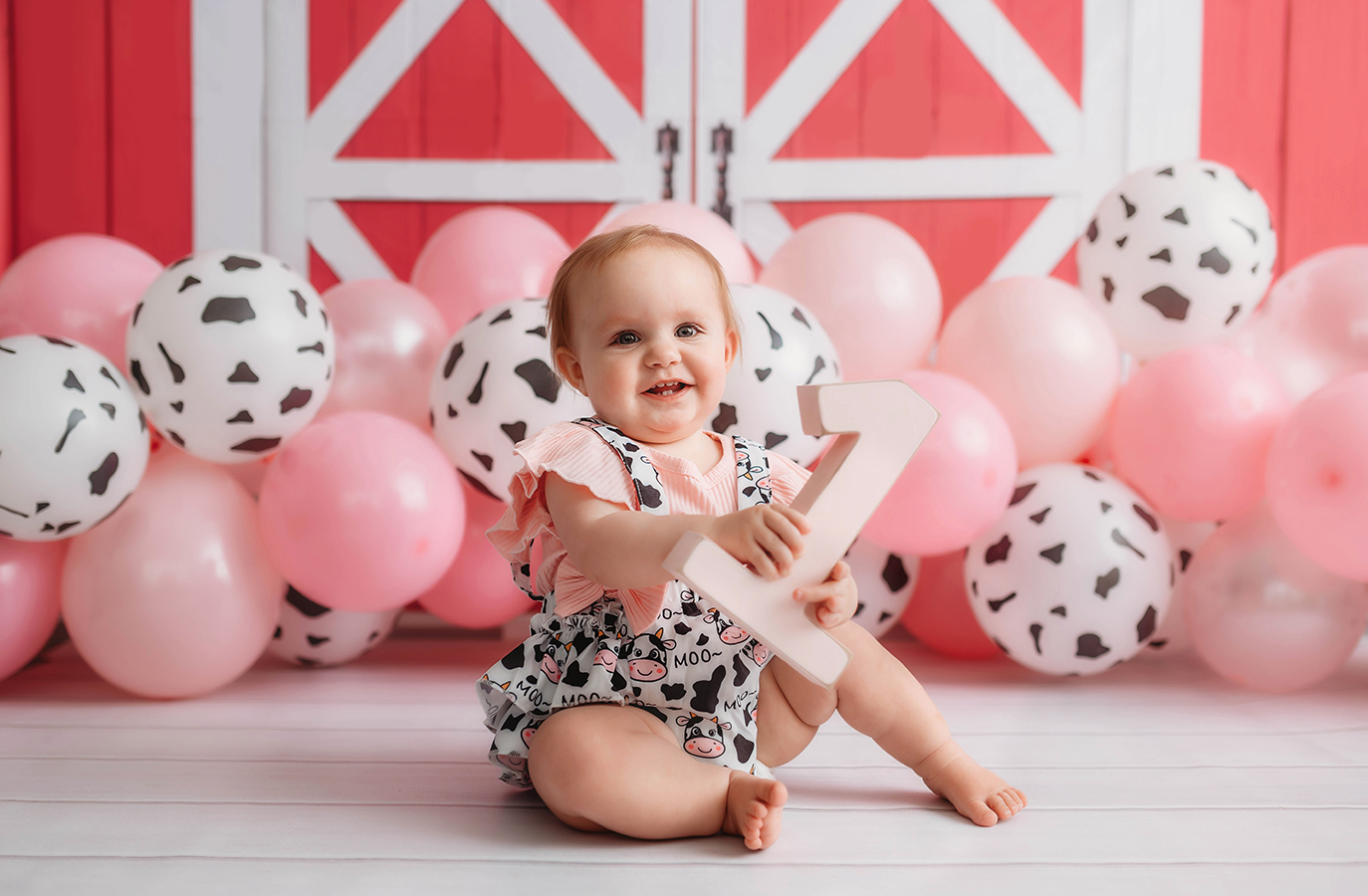 Baby celebrates first birthday with a cake smash photoshoot in Asheville, NC baby photo studio.