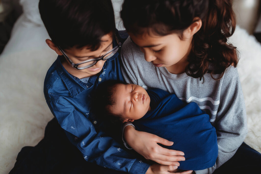Newborn Baby posed with his siblings for Newborn Portrait Session at Asheville, NC Newborn Photography Studio.