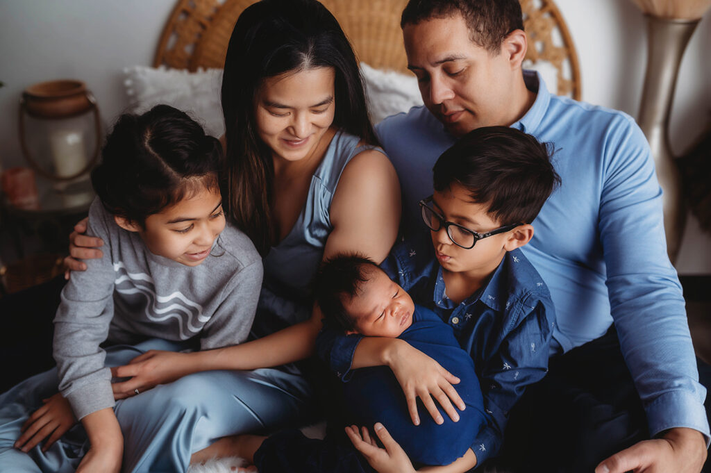 Newborn Baby posed with his family for Newborn Portrait Session at Asheville, NC Newborn Photography Studio.