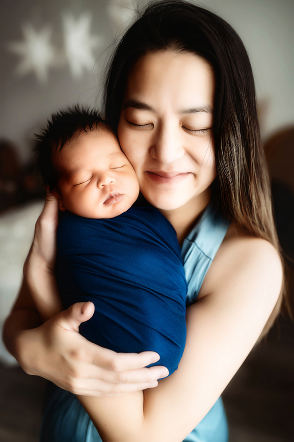 Newborn Baby posed with his mother for Newborn Portrait Session at Asheville, NC Newborn Photography Studio.
