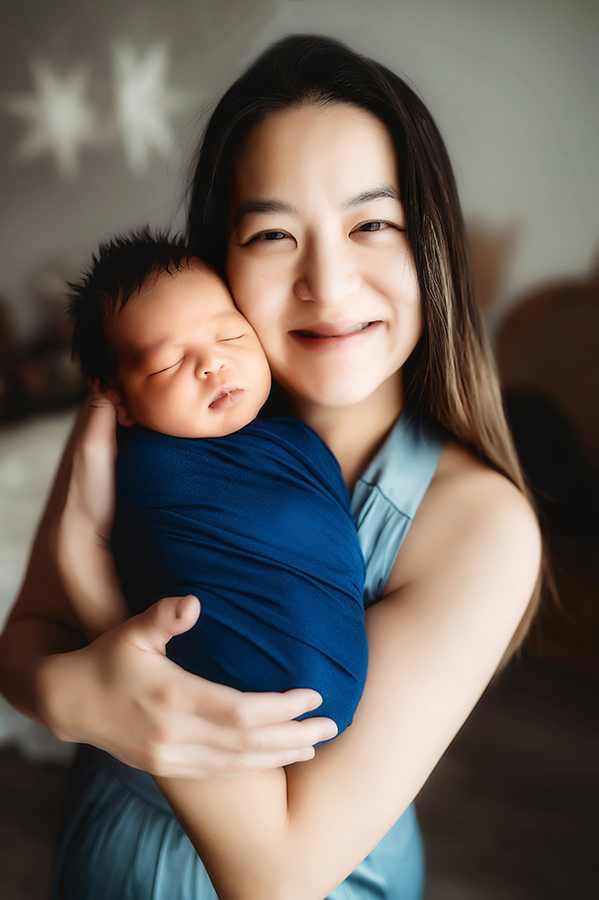 Newborn Baby posed with his mother for Newborn Portrait Session at Asheville, NC Newborn Photography Studio.