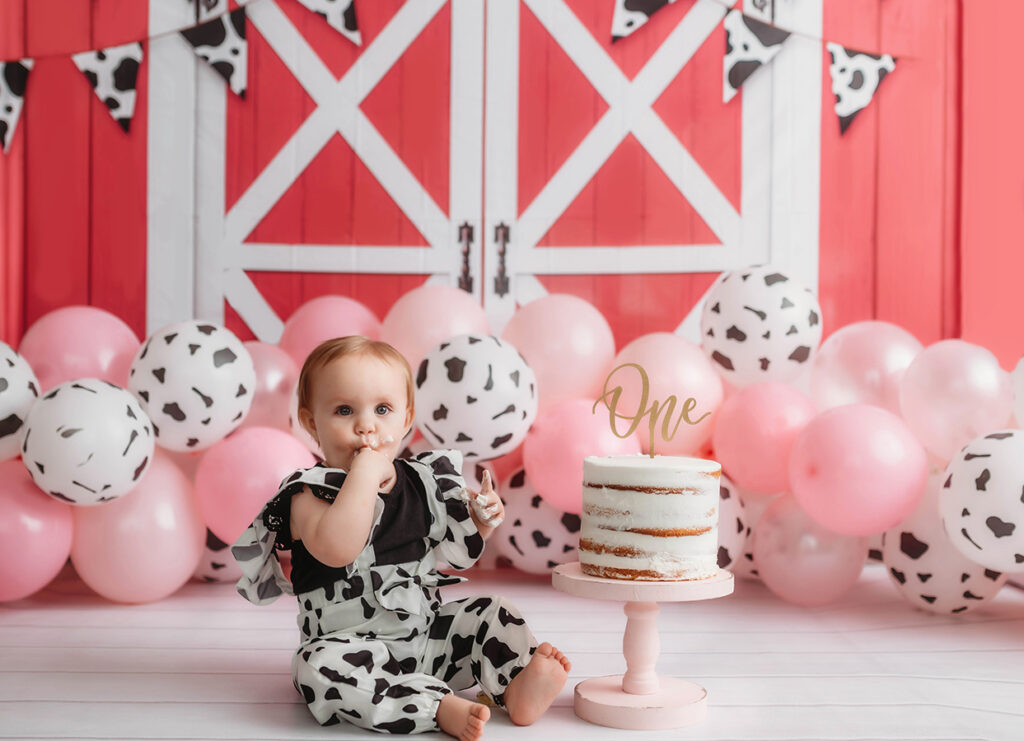 Baby enjoys birthday cake during a photoshoot in Asheville.