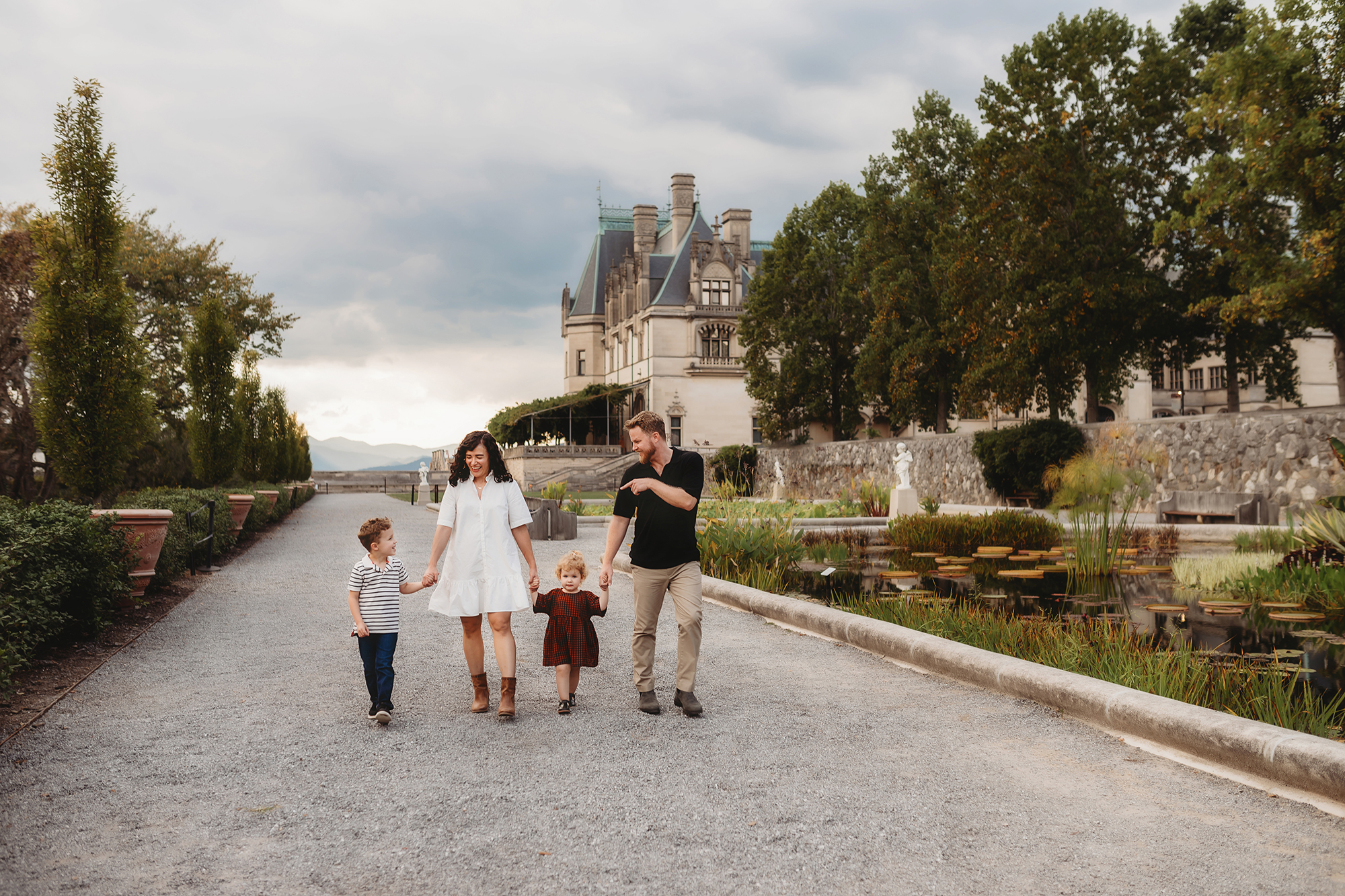 Family walks along the Italian Gardens at Biltmore Estate during their Fall Family Photoshoot in Asheville, NC.