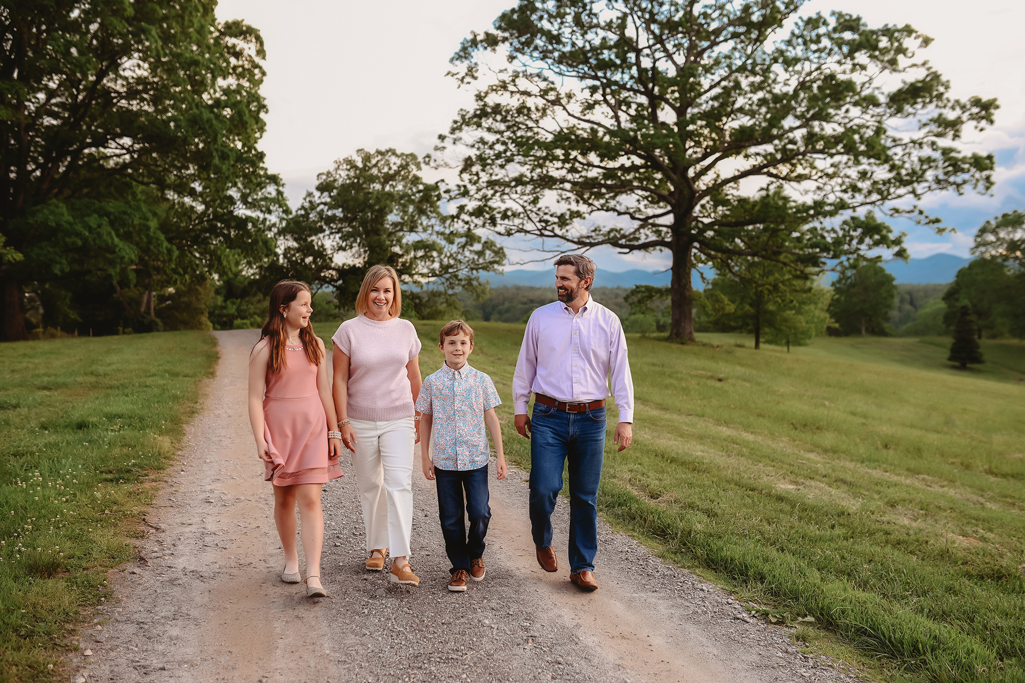Parents walk with their children during Family Pictures at Biltmore Estate during their Family Vacation in Asheville.