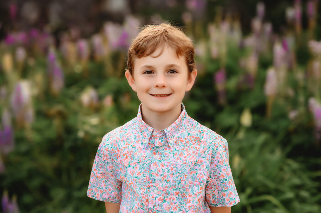 Little boy smiles at the camera during Family Photoshoot at Biltmore Estate in Asheville, NC. 