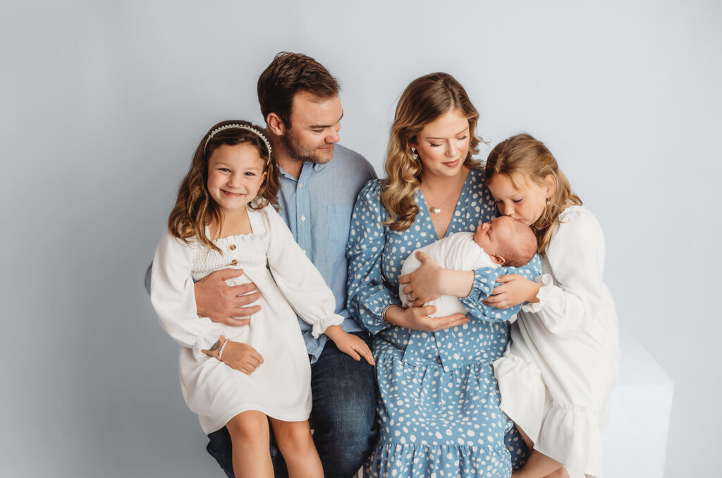 Portrait of a Family holding Newborn Baby boy during his Infant Photoshoot in Asheville.
