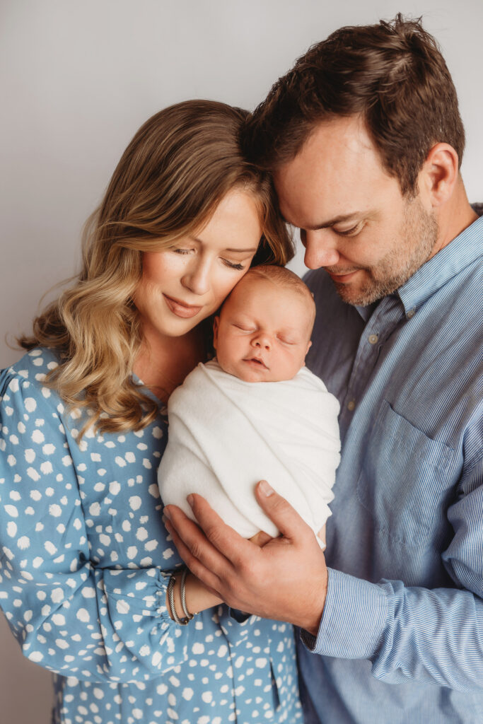 Portrait of a Parents holding their Newborn Baby boy during his Infant Photoshoot in Asheville.