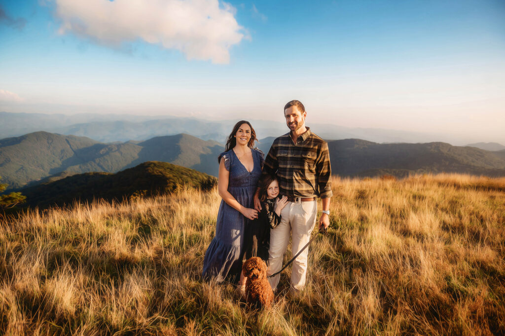 Family poses for Portraits on a mountain top while exploring one of the Best Family Friendly Hikes near Asheville. 
