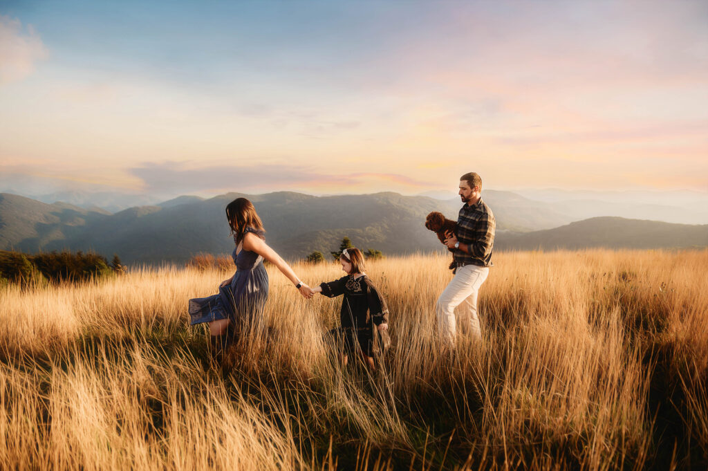 Family walks across a mountain top in Asheville, NC during their Family Portrait Session.