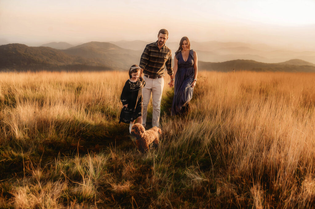 Family walks along a mountain top for Portraits while exploring one of the Best Family Friendly Hikes near Asheville. 