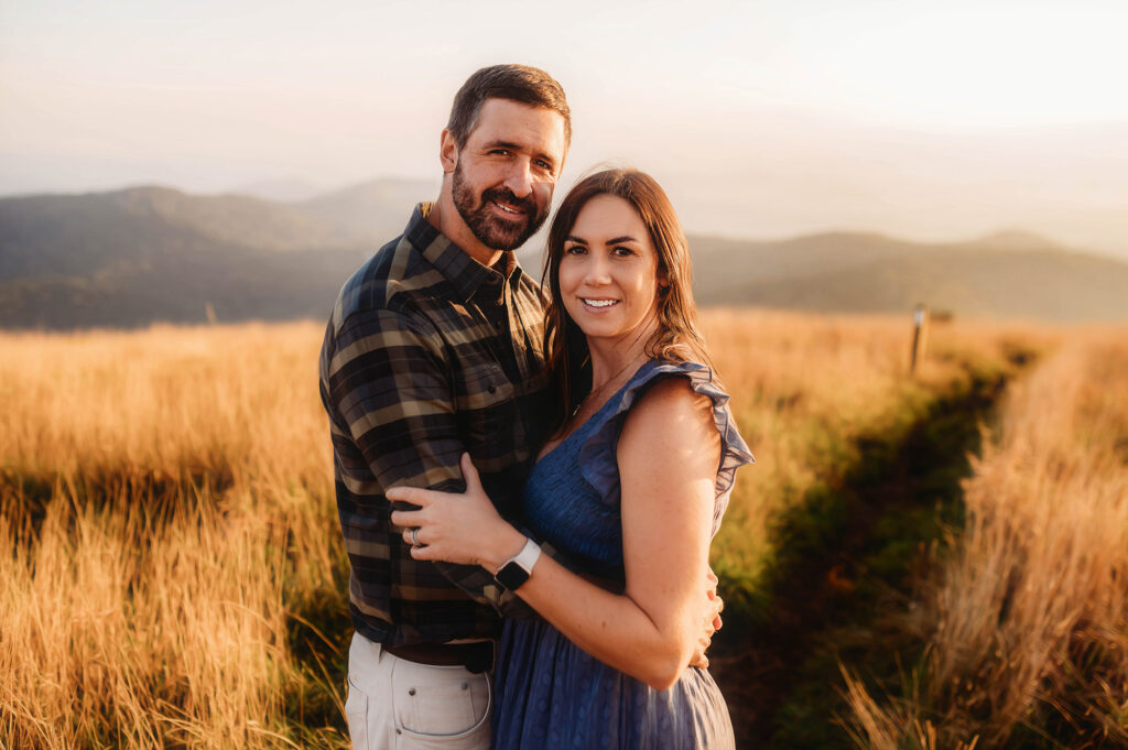 Couple poses for Portraits on a mountain top while exploring one of the Best Family Friendly Hikes near Asheville. 