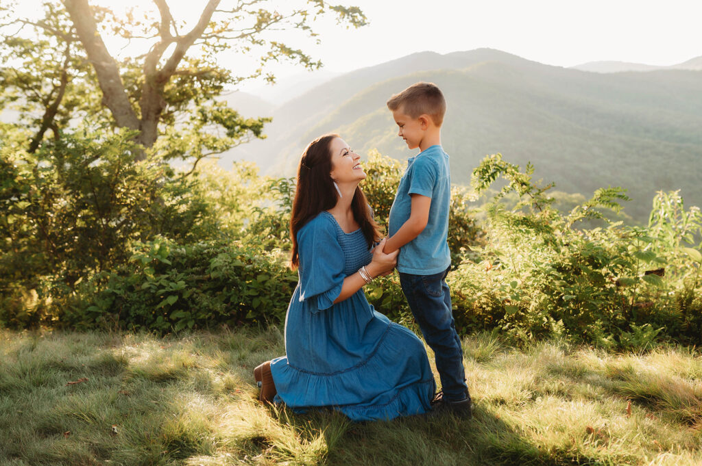 Mother holds her son's hands during Family Photos on the Blue Ridge Parkway in Asheville, NC. 