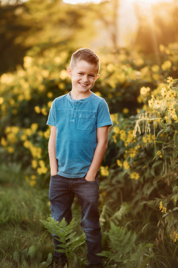 Little boy poses for family portraits on the Blue Ridge Parkway in Asheville, NC.